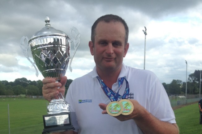 Steve poses with his two medals and trophy